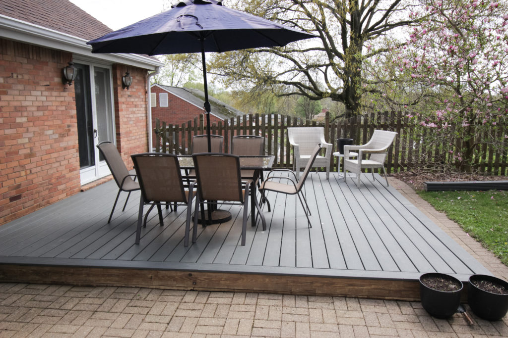 Image of finished deck makeover with table and chairs.
