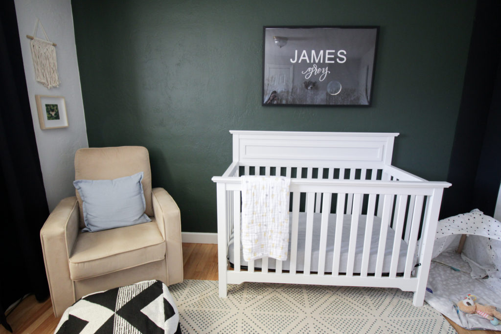 Image of a nursery featuring artwork, a crib, and a glider.